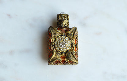 Vintage Jeweled Brass Filigree Perfume Bottle – Amber Glass, Clear Rhinestone Floral Medallion, Crystal Prism Stopper
