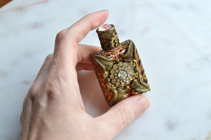 Vintage Jeweled Brass Filigree Perfume Bottle – Amber Glass, Clear Rhinestone Floral Medallion, Crystal Prism Stopper
