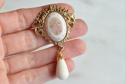 Vintage 1928 Jewelry Co. Pink Porcelain Rose Brooch with Teardrop Dangle, Victorian Revival Ornate Gold Tone Filigree Pin