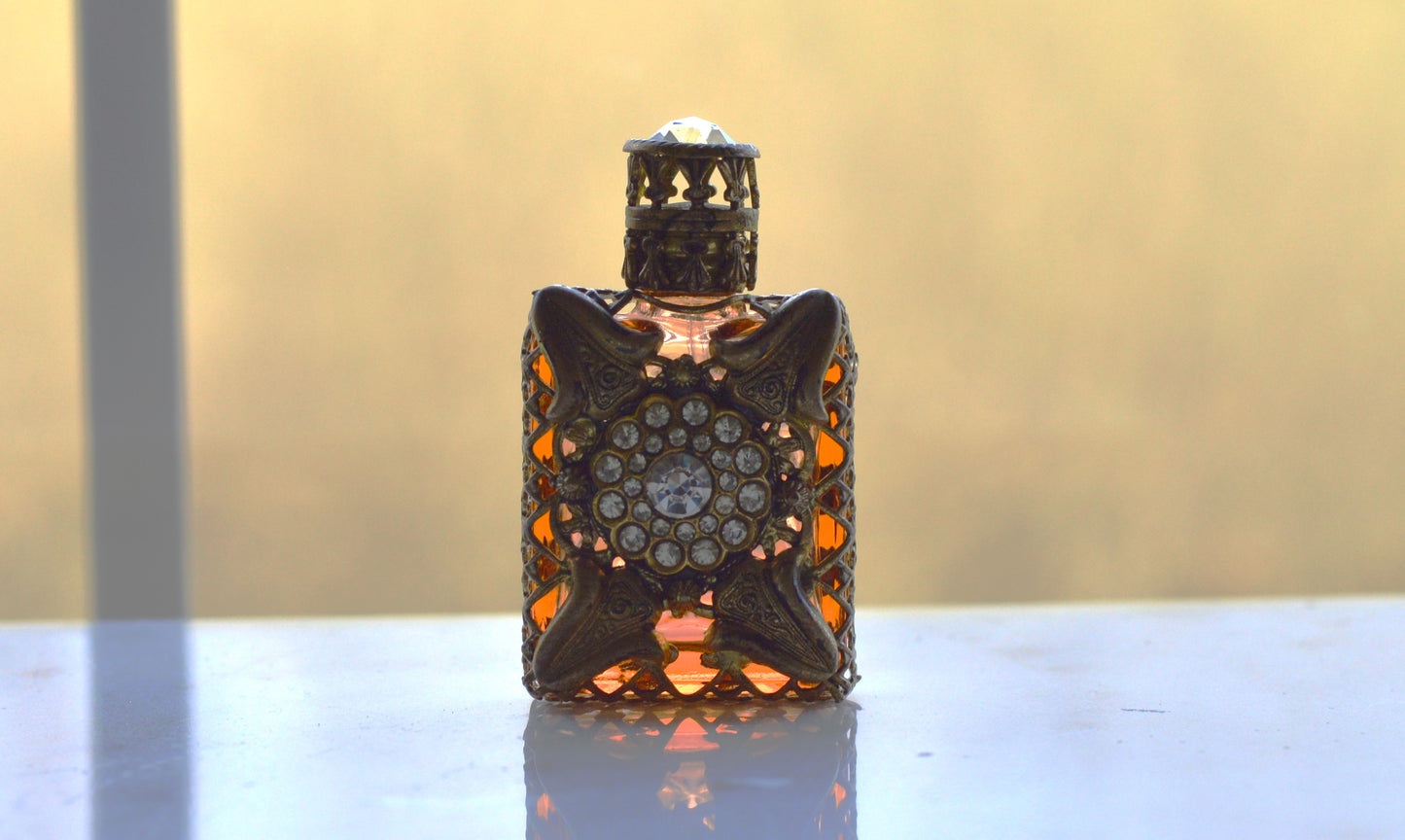 Vintage Jeweled Brass Filigree Perfume Bottle – Amber Glass, Clear Rhinestone Floral Medallion, Crystal Prism Stopper